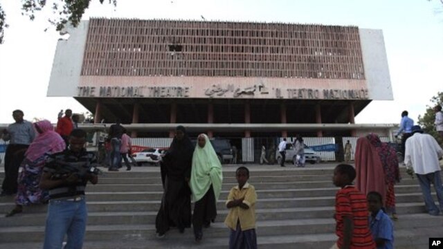 Residents gather outside the reopened National Theater in Somalia's capital Mogadishu, March 19, 2012. In the roofless, bullet-ridden building that houses Mogadishu's National Theater, Somali musicians staged a concert for the first time in 20 years, a si