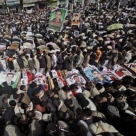 Anti-government protestors pray around the bodies of the demonstrators who were killed on Friday's clashes with Yemeni security forces, during their funeral procession in Sanaa,Yemen, March 20, 2011