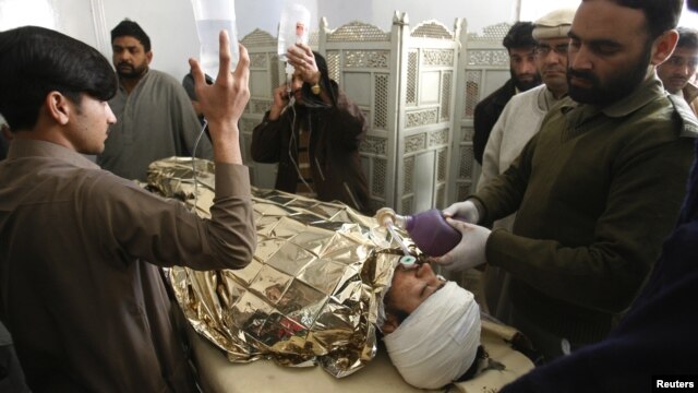 Anti-polio campaign worker Hilal Khan (C), who was shot and badly injured by unidentified gunmen, is treated at Lady Reading Hospital in Peshawar, Pakistan, December 19, 2012.