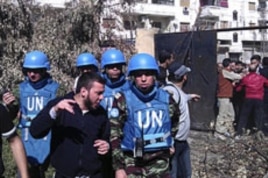 Members of the first U.N. monitoring team, together with members of the Syrian Free Army, visit Homs, Syria, April 21, 2012.