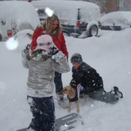 A woman and her children walking their dog and playing in the snow, Fairfax, Virginia, 7 Feb. 2010