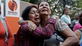 Supporters of Venezuela's President Hugo Chavez weep as she learn that Chavez has died through an announcement by the vice president in Caracas, Venezuela, Tuesday, Mar. 5, 2013.