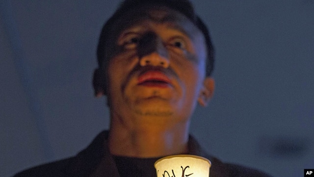 An exiled Tibetan participates in a candlelit vigil to show solidarity with self-immolators in Tibet in Dharmsala, India, Nov. 28, 2012.