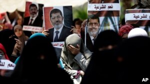 A supporter of ousted Egyptian President Mohammed Morsi cries during a protest near the University of Cairo.