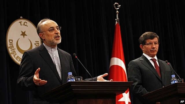 Turkey's Foreign Minister Ahmet Davutoglu, right, and Iranian counterpart Ali Akbar Salehi, Ankara, Oct. 21, 2011.