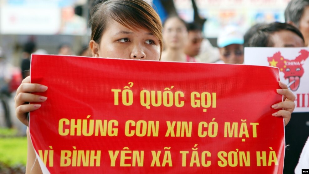 Người phụ nữ cầm biểu ngữ tại một cuộc biểu tình phản đối Trung Quốc ở Hà Nội, ngày 14/8/2011.