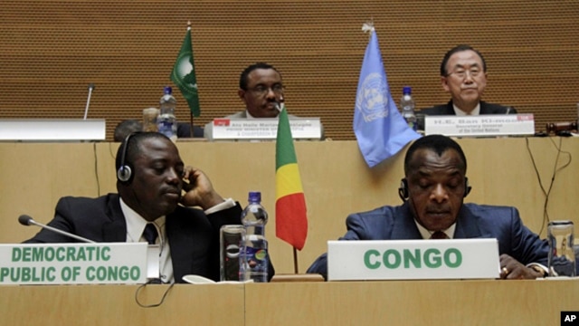 Front row, left to right,  Joseph Kabila Kabange President of the Democratic Republic of Congo, and Denis Sanssou N'guesso, President of the Republic of Congo, during the signing of the Congo peace deal in Addis Ababa, Ethiopia,  Feb. 24, 2013. 