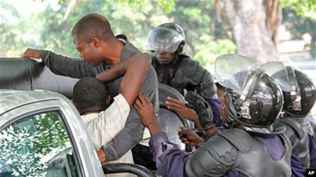 Young men suspected of being militant supporters of opposition candidate Etienne Tshisekedi are forced into a police truck as they are arrested near opposition party headquarters in the Limete district of Kinshasa, Congo, December 12, 2011.