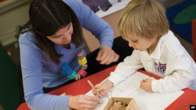 A teacher works with a student at the British School of Chicago, where lessons are individualized based upon how the student learns.