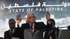 Palestinian President Mahmoud Abbas, waves to the crowd during celebrations for their successful bid to win U.N. statehood recognition in the West Bank city of Ramallah, December 2, 2012.