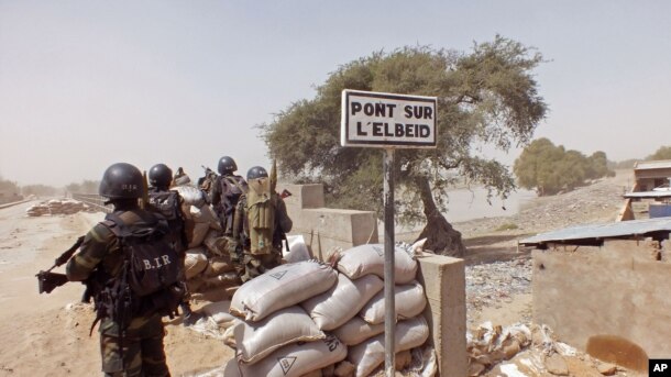 FILE - Cameroonian soldiers stand guard at a lookout post as they take part in operations against Boko Haram militants on Elbeid bridge that separates northern Cameroon form Nigeria's Borno state near the village of Fotokol, Cameroon, Feb. 25, 2015.