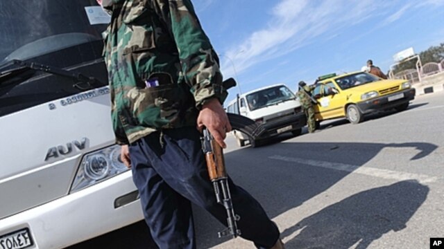 A militant with the Free Syrian Army walks in the northwestern city of Idlib, February 21, 2012.