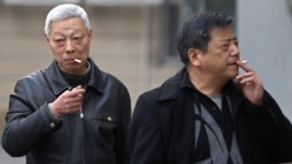 Smokers in a street in Shanghai, China, March 22, 2012. 
