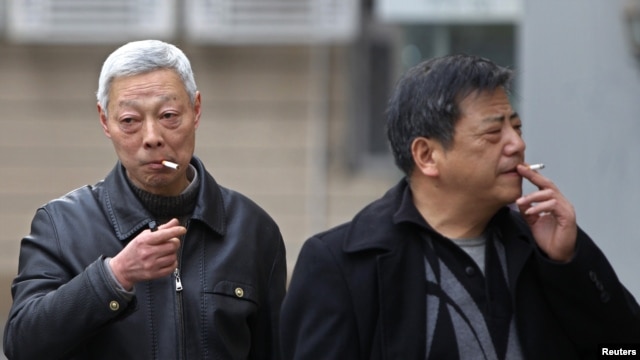 Smokers in a street in Shanghai, China, March 22, 2012. 