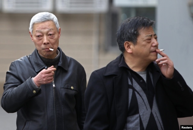 FILE - Smokers are seen on a street in Shanghai, China, March 22, 2012.
