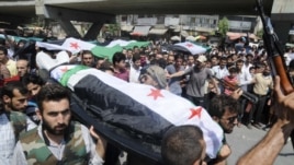 People carry a body of a person killed in clashes in Aleppo, Syria, Friday, July 27, 2012.