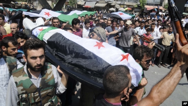 People carry a body of a person killed in clashes in Aleppo, Syria, Friday, July 27, 2012. 