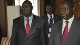 Michel Am-Nondokro Djotodia (L), leader of Central African Republic's (CAR) Seleka rebel alliance, stands beside CAR's President Francois Bozize (R) during peace talks between the government and the opposition rebels in Libreville, Gabon, January 11, 2013.