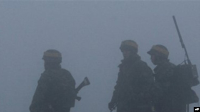 South Korean Marines patrol on Yeonpyeong island, South Korea, ahead of expected live-fire artillery exercises, Dec. 20, 2010.