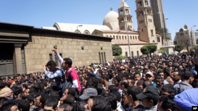 Egyptians converge on Cairo's main Coptic Cathedral to pay their last respects to Pope Shenouda, who died Saturday. Sunday, March18, 2012.
