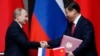 Xi, Putin Promise Closer Ties