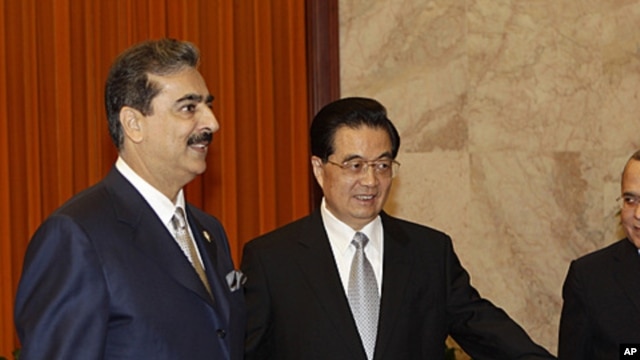 Pakistani Prime Minister Yousuf Raza Gilani, left, is shown the way by Chinese President Hu Jintao during a meeting at the Great Hall of the People in Beijing, May 20, 2011