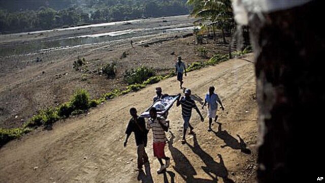 Michelet Compere, 14, suffering from cholera, is carried on a stretcher by relatives during their four-hour journey from a remote village in Pond Chevalier to the hospital in Grande Riu Du Nord village, Haiti, Nov 29, 2010