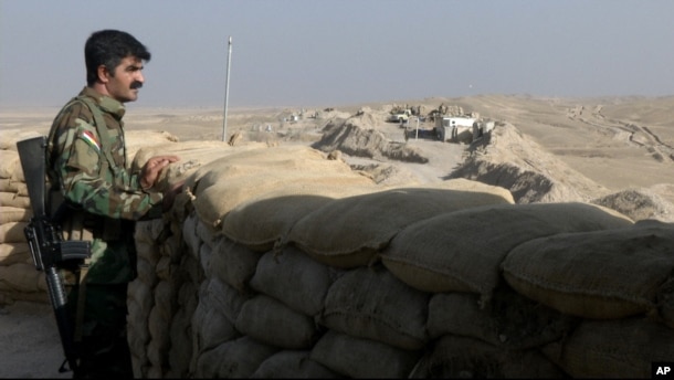 A militiaman from the Kurdistan Freedom Party, an Iranian Kurdish opposition group, stands behind his truck-mounted machine gun on a section of the frontline near the Iraqi city of Kirkuk on Sept. 5, 2016.