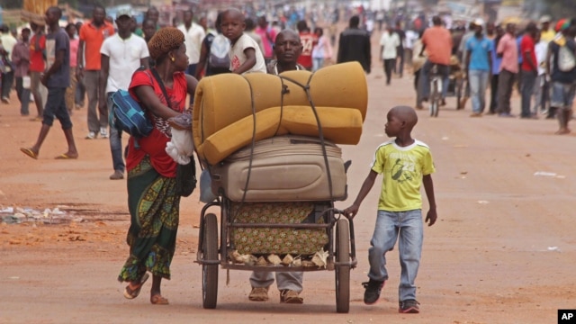 FILE - A family with its belongings on a makeshift cart is seen in Bangui, Central African Republic, Sept. 30, 2015. Many residents are fleeing sectarian clashes between rivaling Christian and Muslim militias.