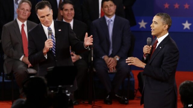 President Barack Obama (R) and Republican presidential candidate Mitt Romney spar in their second debate in Hempstead, NY, October 16, 2012.