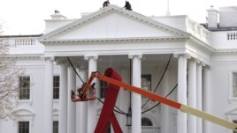A large red ribbon is installed on the North Portico of the White House to mark World AIDS Day on December 1, in Washington, D.C., November 30, 2012.