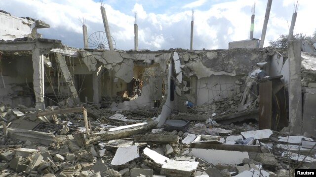 Buildings damaged by what activists said were missiles fired by a Syrian Air Force fighter jet operated by forces loyal to Syrian President Bashar al-Assad are seen at Houla, near Homs December 6, 2012. 