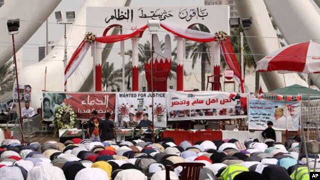 Anti-government protesters participate during midday prayers at the Pearl roundabout in Manama, Bahrain, February 25, 2011