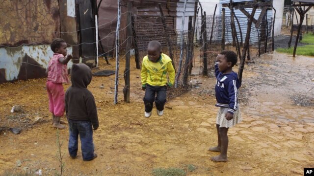 Children jump rope at the Tudor Shaft squatter settlement near Randfontein, west of Johannesburg, South Africa, January 26, 2011.