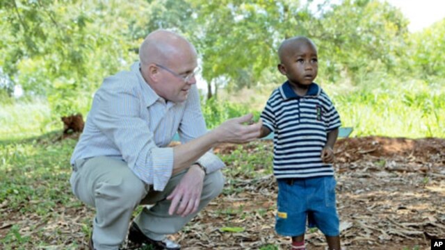 Chip Lyons with child in Kenya.