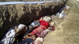 This citizen journalism image provided by Shaam News Network SNN, taken on Sunday, Aug. 26, 2012, purports to show people killed by shabiha, pro-government militiamen, being buried in a mass grave in Daraya, Syria. According to activists' accounts, govern