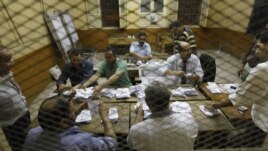 Egyptian elections officials count ballots at a polling center during the second day of the presidential runoff, in Cairo, Egypt, Sunday, June 17, 2012.