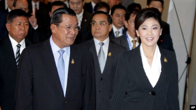 Cambodia's Prime Minister Hun Sen, left, walks with his Thai counterpart Yingluck Shinawatra as they attend ASEAN-UN Summit in Nusa Dua, Bali, Indonesia, file photo. 