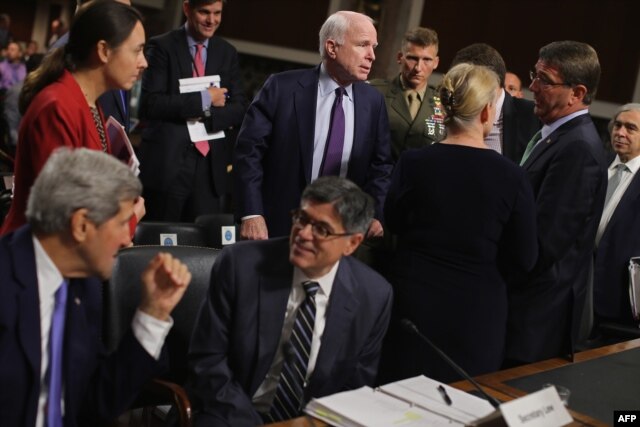Senate Armed Services Committee Chairman John McCain, center, talks with, from left, Secretary of State John Kerry, Treasury Secretary Jacob Lew, Senator Kirsten Gillibrand, Defense Secretary Ashton Carter and Energy Secretary Ernest Moniz on Capitol Hill