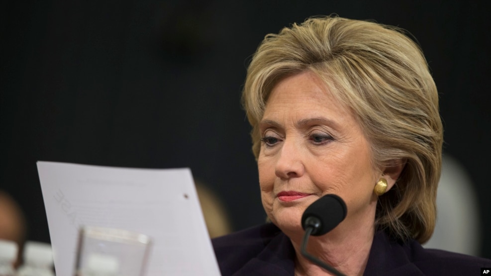 FILE - Democratic presidential candidate, former Secretary of State Hillary Rodham Clinton looks at an email sent by Ambassador Chris Stevens during her testimony before the House Benghazi Committee.