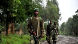 M23 rebel group soldiers patrol in Rangira, near Rutshuru, DRC, October 17, 2012.