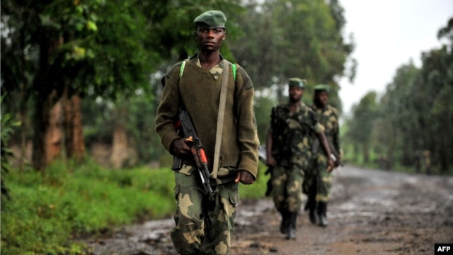 M23 rebel group soldiers patrol in Rangira, near Rutshuru, DRC, October 17, 2012.