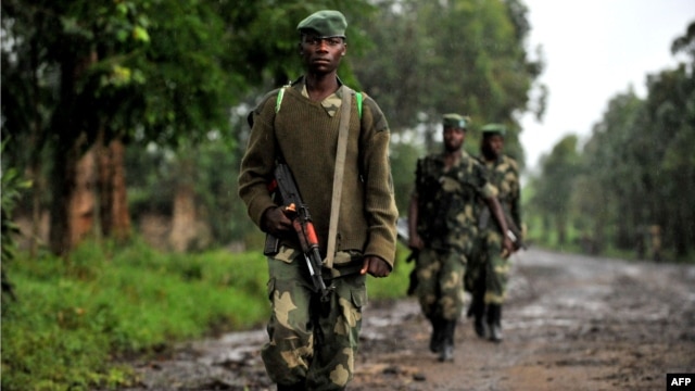 M23 rebel group soldiers patrol in Rangira, near Rutshuru, DRC, October 17, 2012.