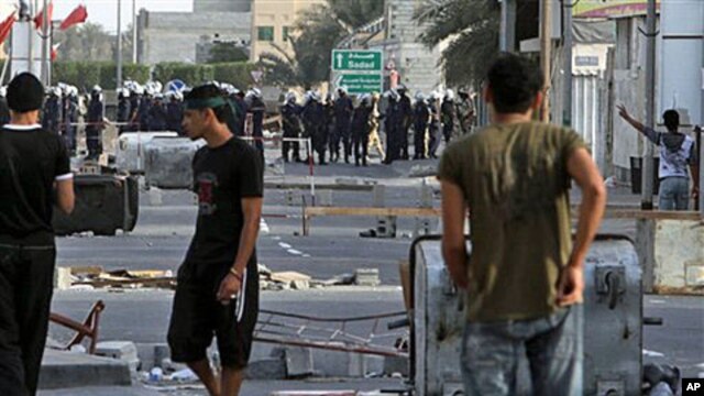 Bahraini riot police and soldiers move in on anti-government protesters March 25, 2011, in the western Shi'ite Muslim village of Malkiya, firing tear gas when villagers defied martial law by holding a protest march