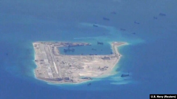 Chinese dredging vessels are purportedly seen around Fiery Cross Reef in the disputed Spratly Islands in the South China Sea in this image from video taken by a P-8A Poseidon surveillance aircraft provided by the U.S. Navy, May 21, 2015.