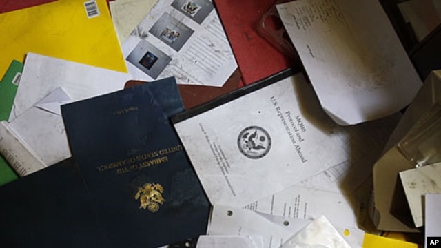A document reading "MQ116 Protocol and US Representation Abroad" is seen in the ransacked office of the US Ambassador and Deputy Chief of Mission during a visit for the press in the vandalized US Embassy in Tripoli, Libya, September 12, 2011.