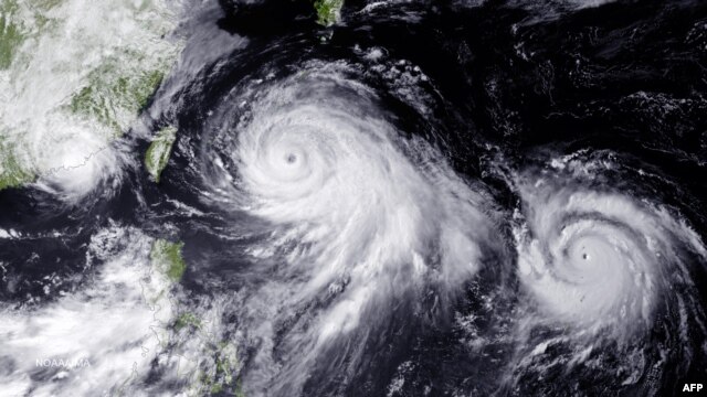 This NOAA photo shows two typhoons in the Philippine Sea and a tropical storm near the China coast near Hong Kong and Macau which have the region on alert, taken July 10, 2015.