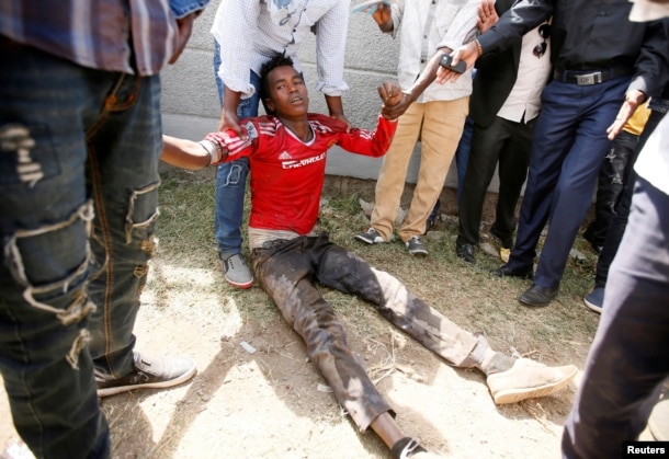 FILE -- People assist an injured protester during Irrechaa, the thanksgiving festival of the Oromo people in Bishoftu town of Oromia region, Ethiopia.