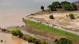 Aerial views shows a road that has been washed away by flood waters in Chokwe, Mozambique, Jan. 30, 2013.