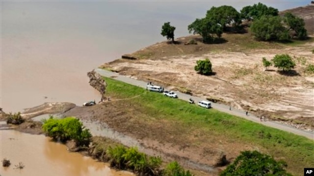 Aerial views shows a road that has been washed away by flood waters in Chokwe, Mozambique, Jan. 30, 2013.